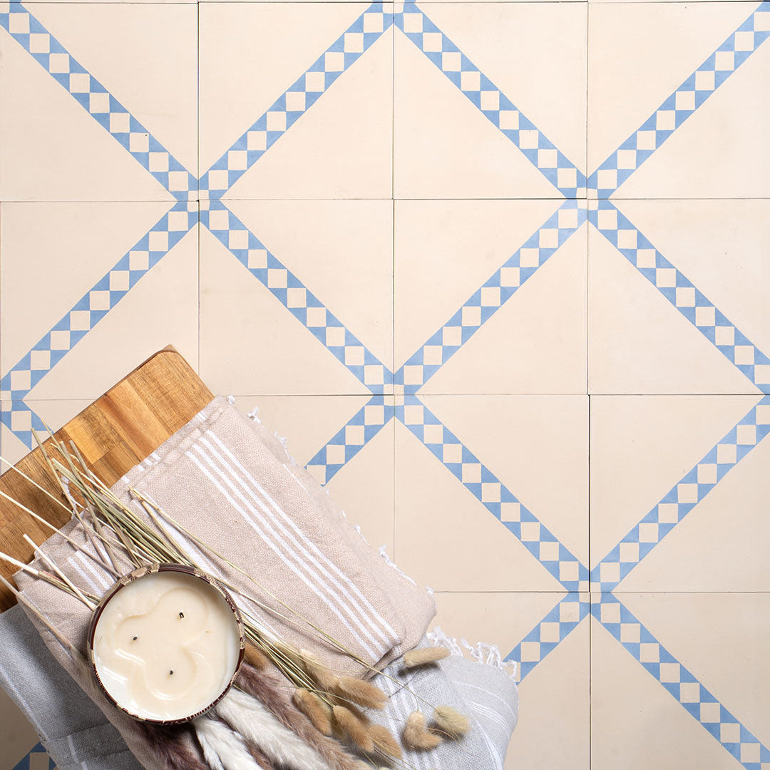 Cement tile featuring a white base with a diagonal blue-and-white checkered stripe, perfect for Mediterranean interiors, accent walls, or patterned floor layouts.