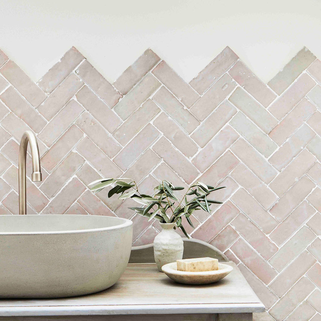 Bathroom vanity with a herringbone tile backsplash