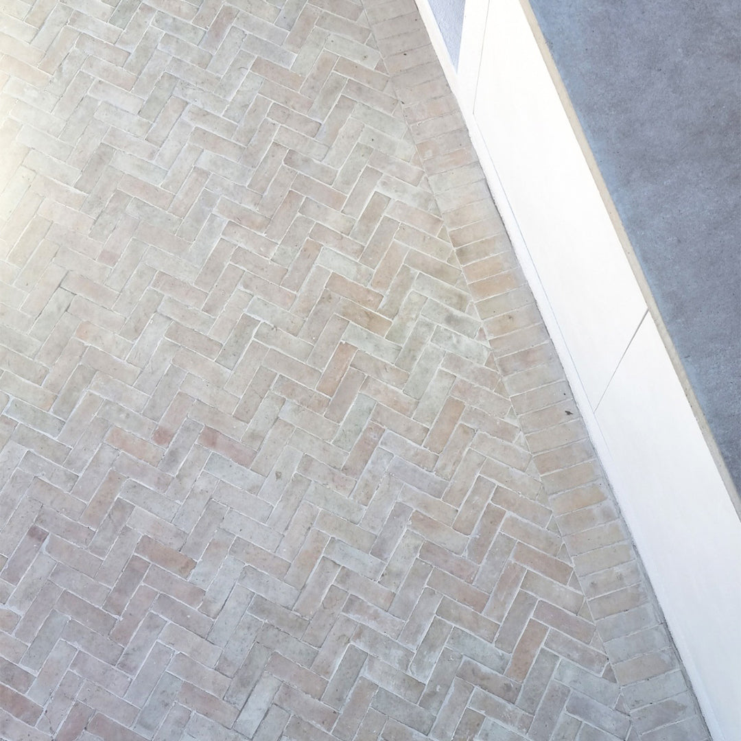 Light herringbone bathroom tile flooring .