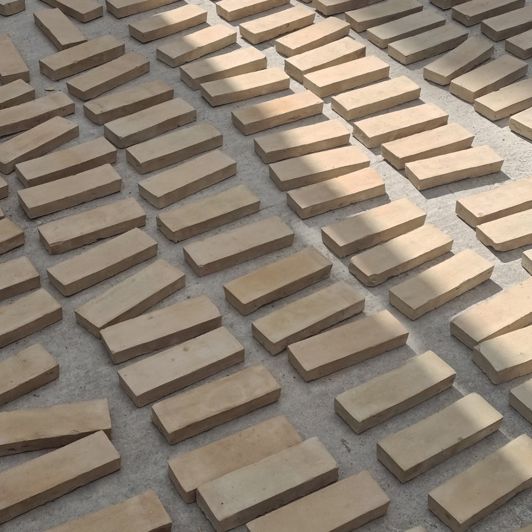 Light curved bathroom bricks arranged in neat rows, ideal for flooring, wall tiling, or creative interior design.