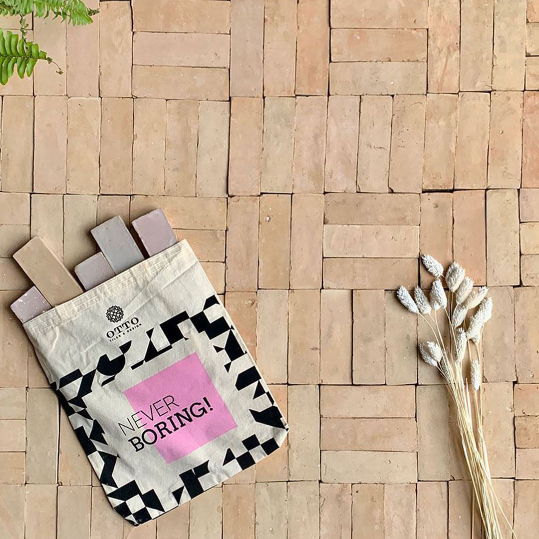 Decorative pillow with 'Never Boring!' text on a woven surface