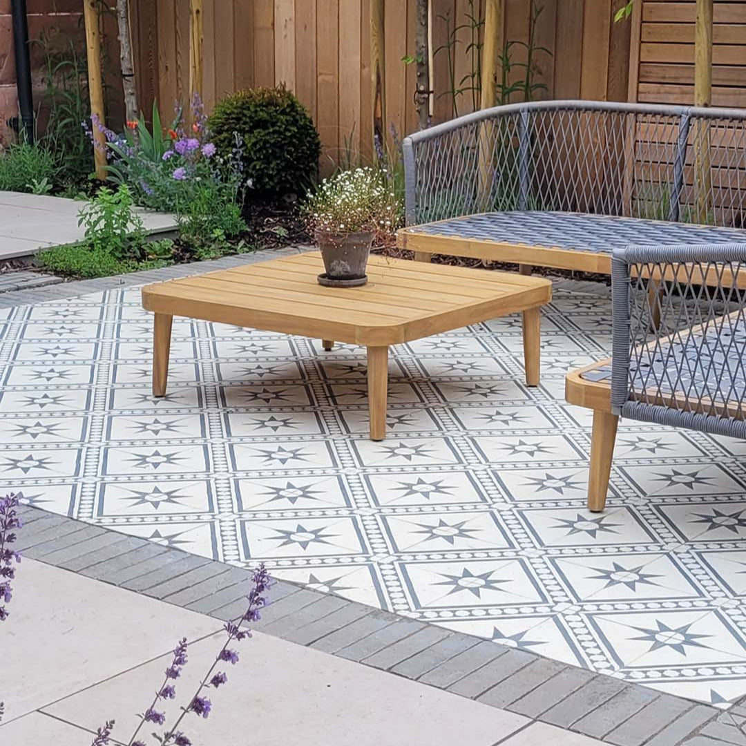 Beige and charcoal cement tile featuring a diagonal geometric pattern with star motifs and bold angular accents, handcrafted matte finish, ideal for Mediterranean-inspired flooring, wall décor, and interior design applications.