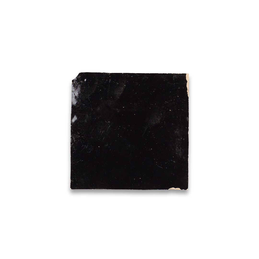 Square piece of black marble on a white background