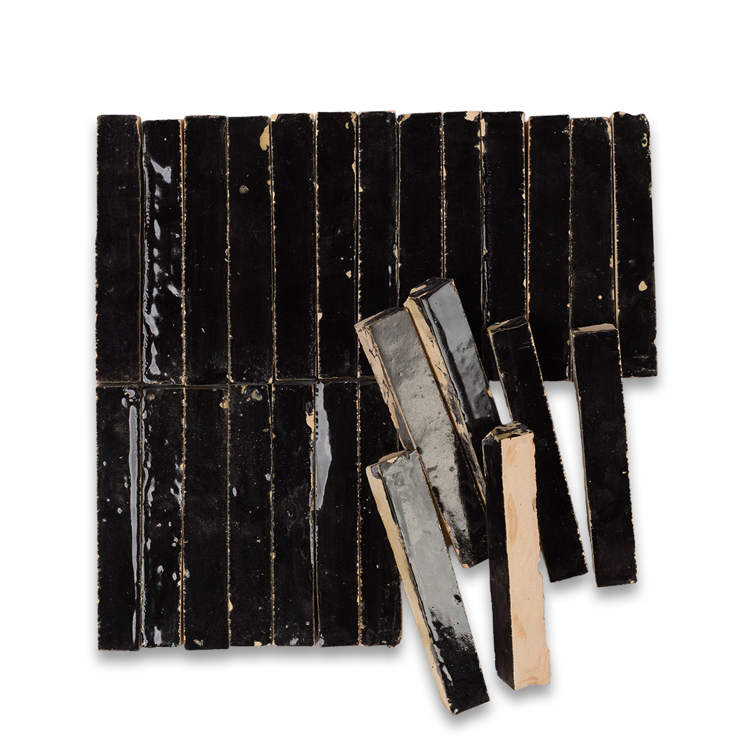 Black rectangular tiles with ribbed texture on a white background