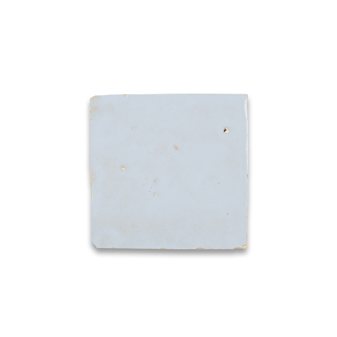 Square earring display card with gold earrings on a white background