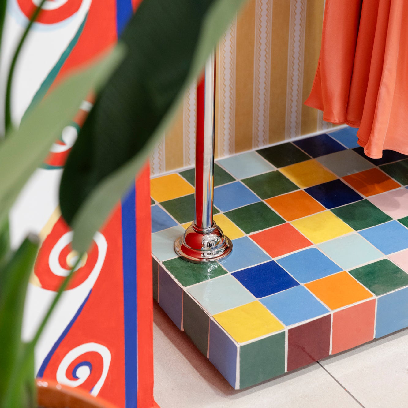 Colorful tiled floor with a plant and decorative elements.