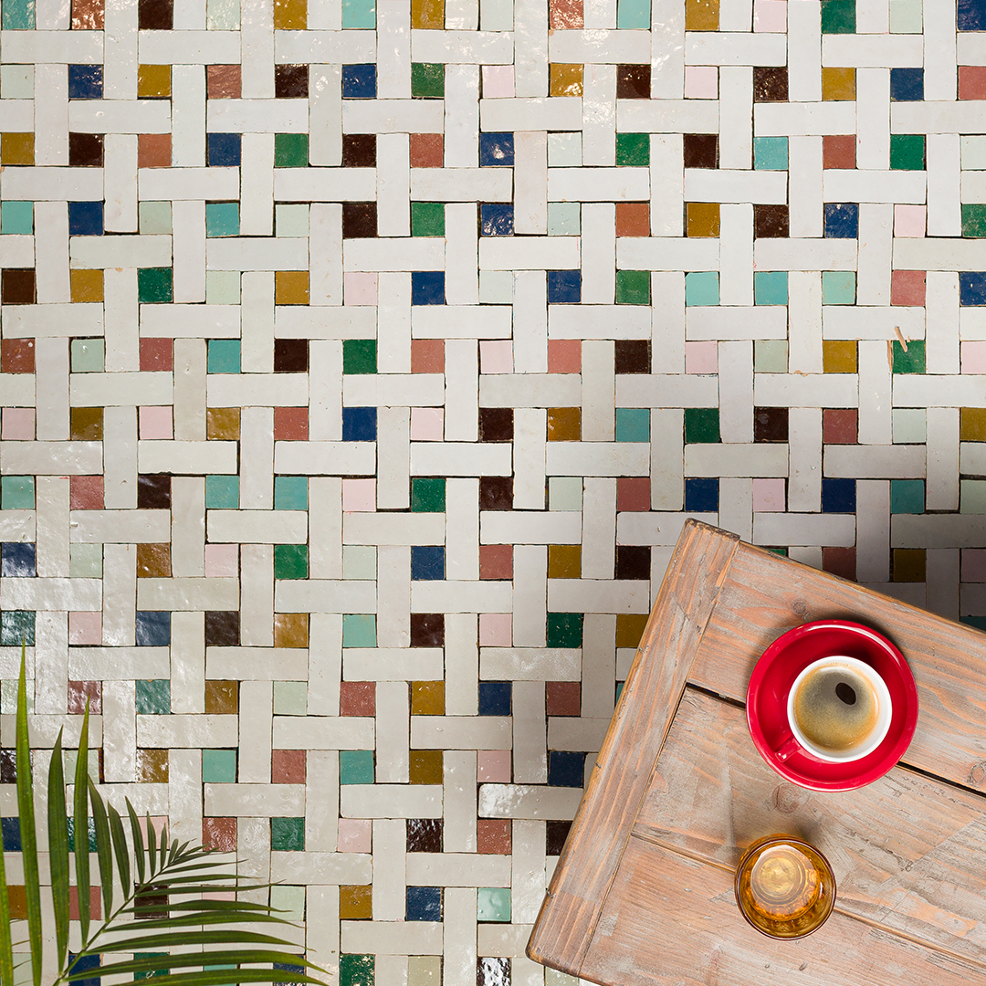 Colorful tile pattern with a wooden table and drinks in the foreground