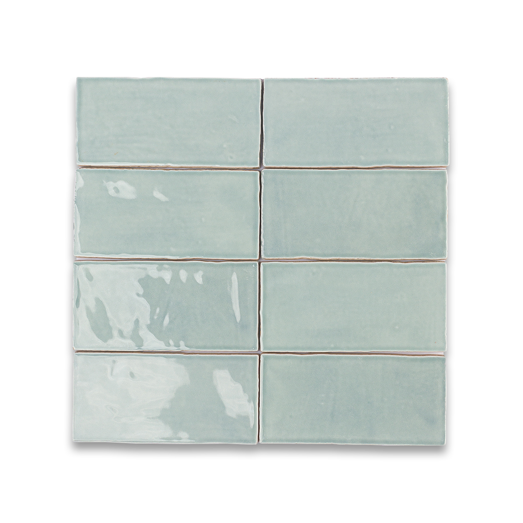 Set of six light blue tiles with brown grout on a white background