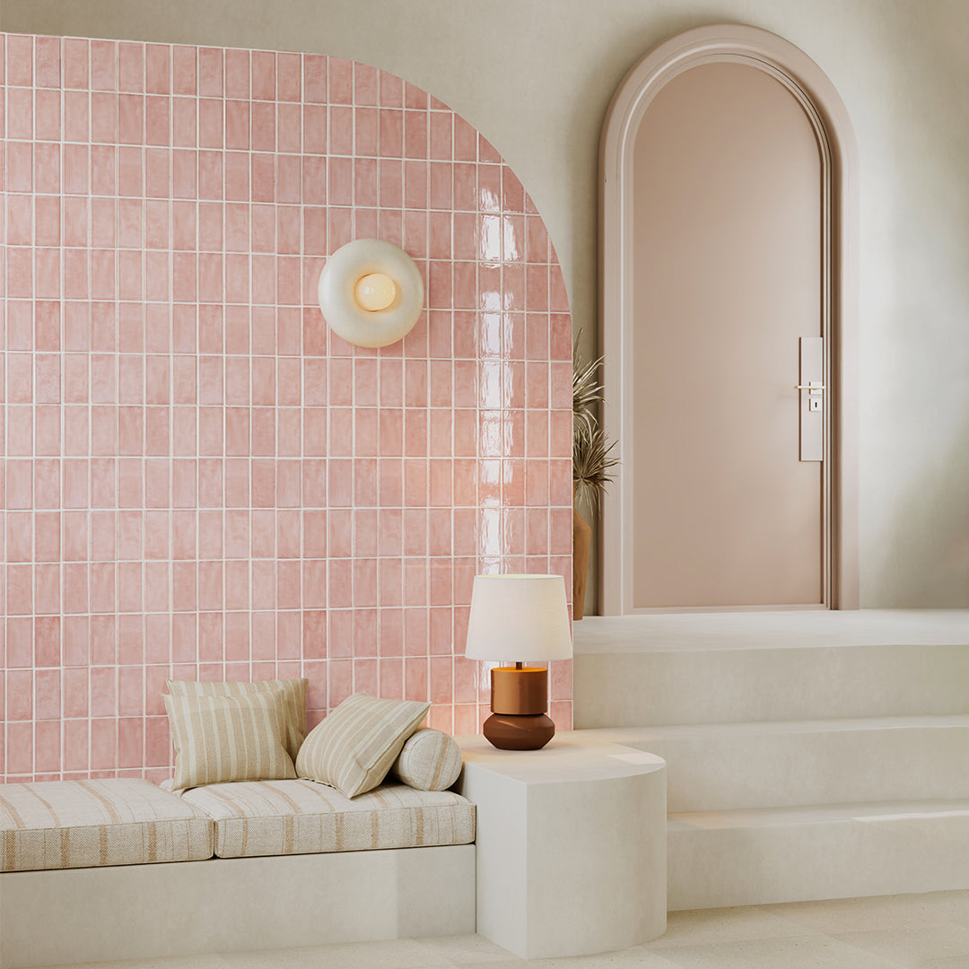 Modern interior with pink tiled wall and beige sofa