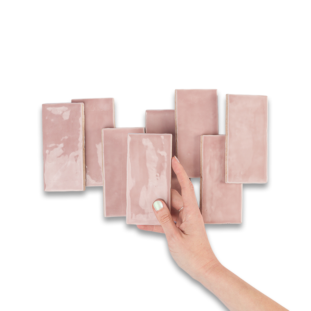 Set of pink rectangular tiles with a hand holding one tile on a white background