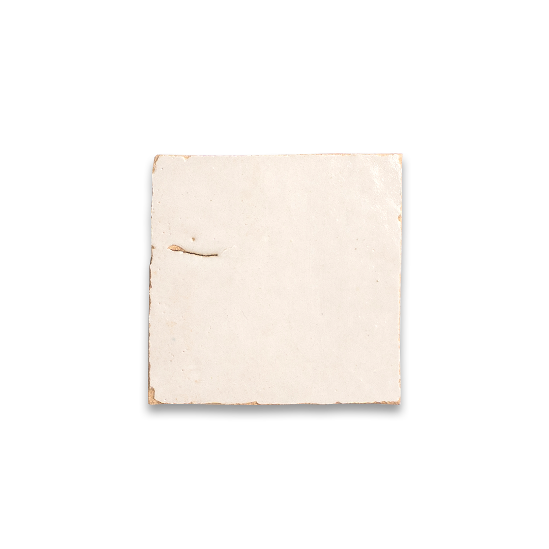 Beige fabric square with a small hole on a white background