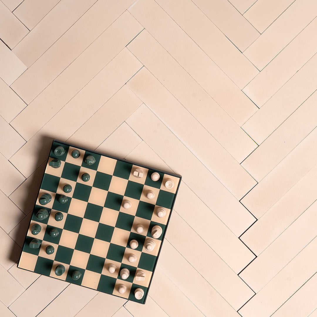 Egg Shell Herringbone cement tile arrangement featuring elongated rectangular tiles in a soft beige tone, smooth matte finish, minimalist modern design ideal for contemporary flooring, wall cladding, and interior décor applications.