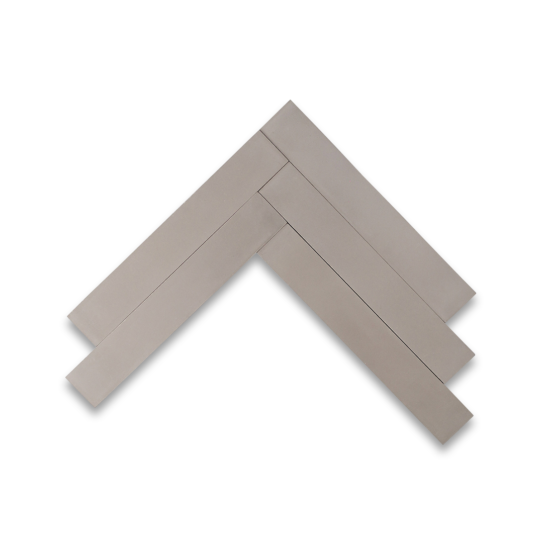 A rectangular herringbone pattern in light gray with a smooth matte finish, ideal for modern, minimalist, or industrial interior flooring and wall design applications.