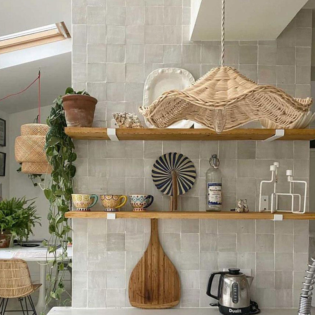 Kitchen interior with wooden shelves, decorative items, and a tiled wall.
