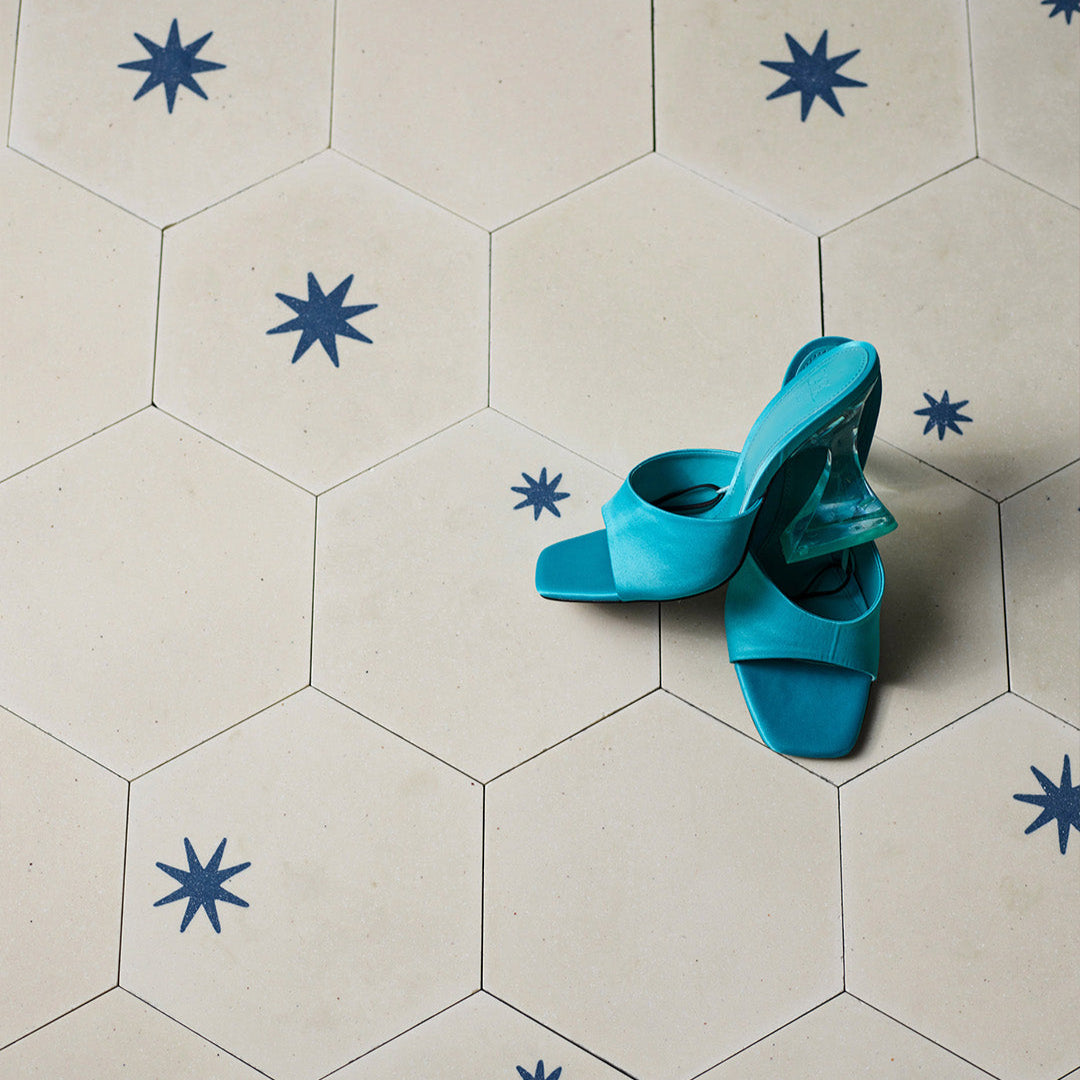 A decorative patterned tile featuring a geometric blue star design, ideal for enhancing modern interiors, walls, and contemporary architectural spaces.