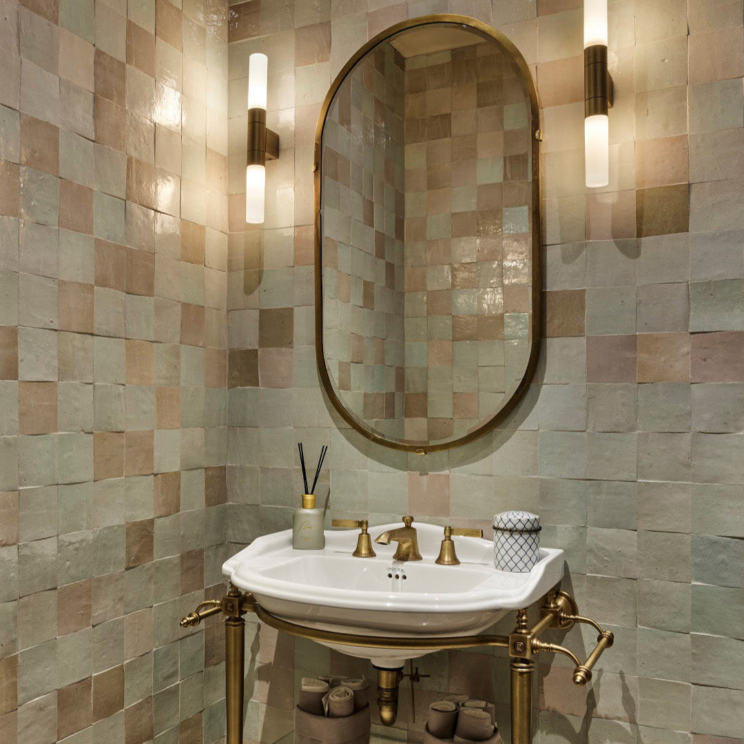 Bathroom with tiled walls, a sink, and decorative elements.