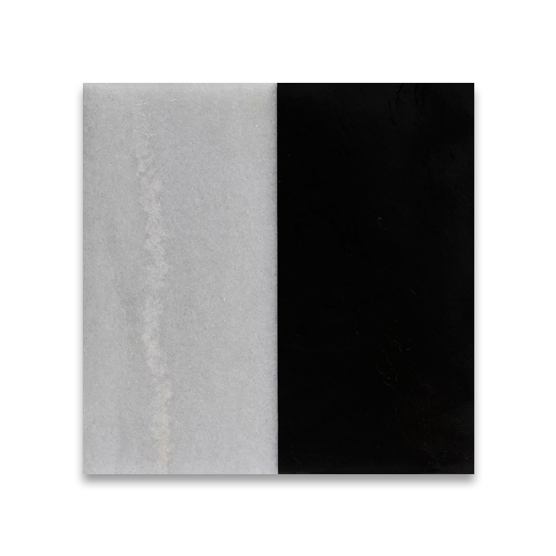Two square tiles, one gray and one black, on a white background