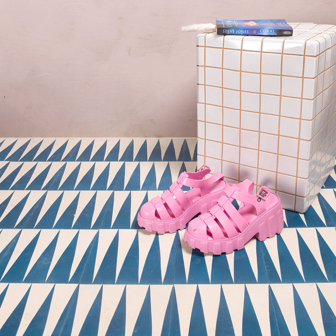 Cement tile featuring alternating deep teal blue and white elongated triangular patterns, matte finish, ideal for modern, geometric, or Mediterranean interior flooring and wall décor applications.