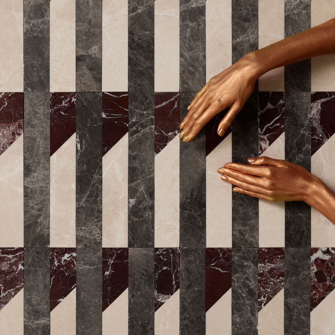 Marble-patterned floor with hands reaching towards it