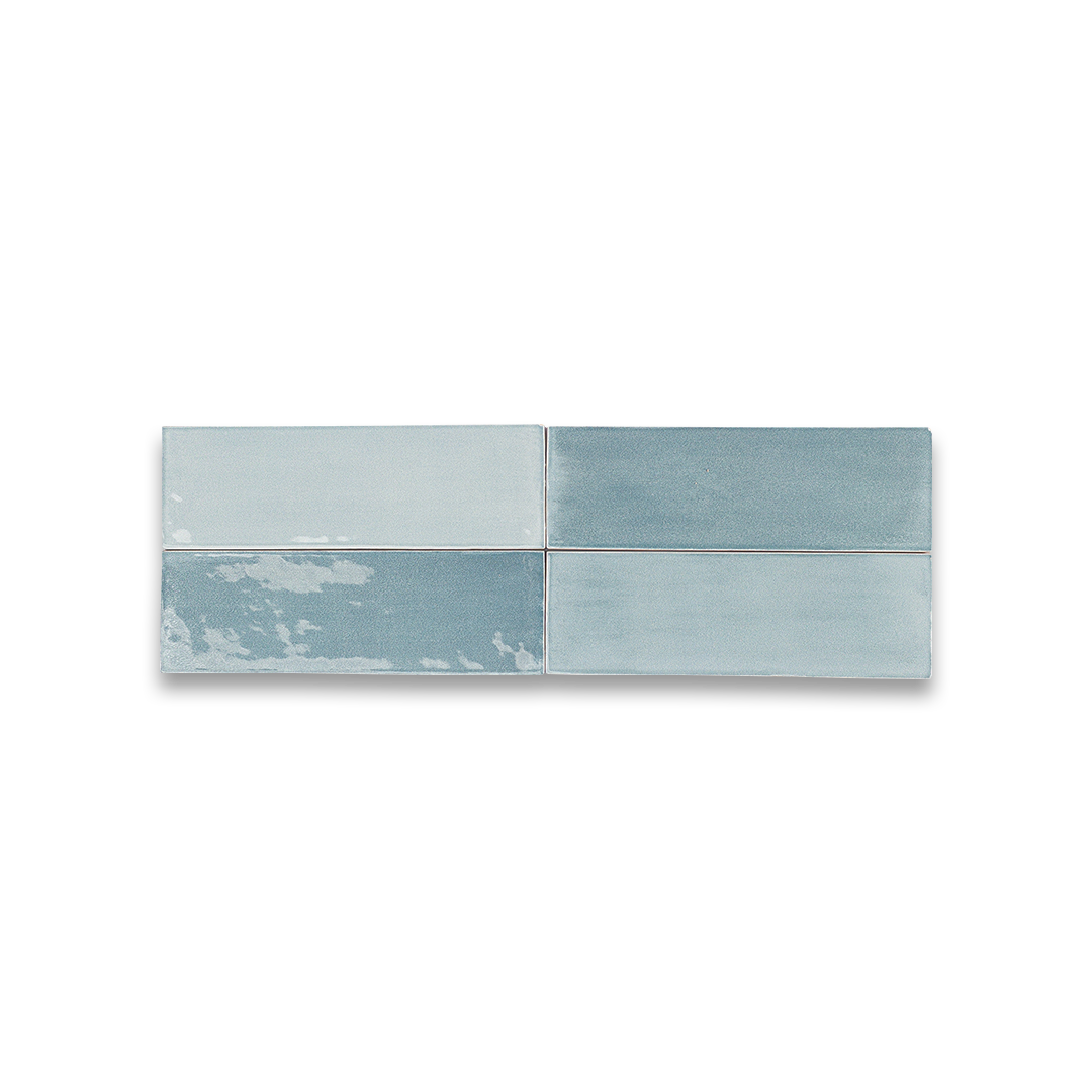 Two blue ceramic tiles with a subtle pattern on a white background