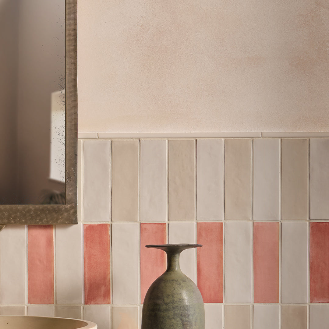 Decorative tiles with a mix of beige, brown, and red colors on a wall.