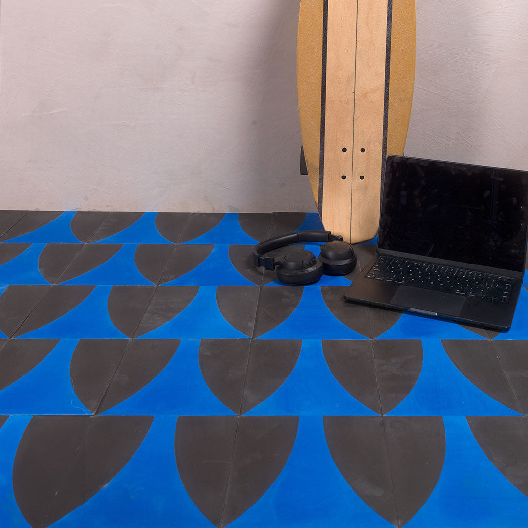A bold geometric design with a curved cobalt blue shape against a charcoal black background, matte finish, ideal for modern or contemporary interior flooring and wall décor.