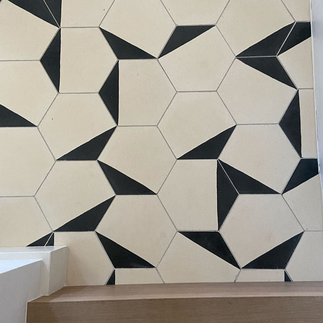 Modern hexagonal tile featuring a matte cream surface with a bold black edge accent, ideal for geometric wall patterns, minimalist flooring, or contemporary interior designs.