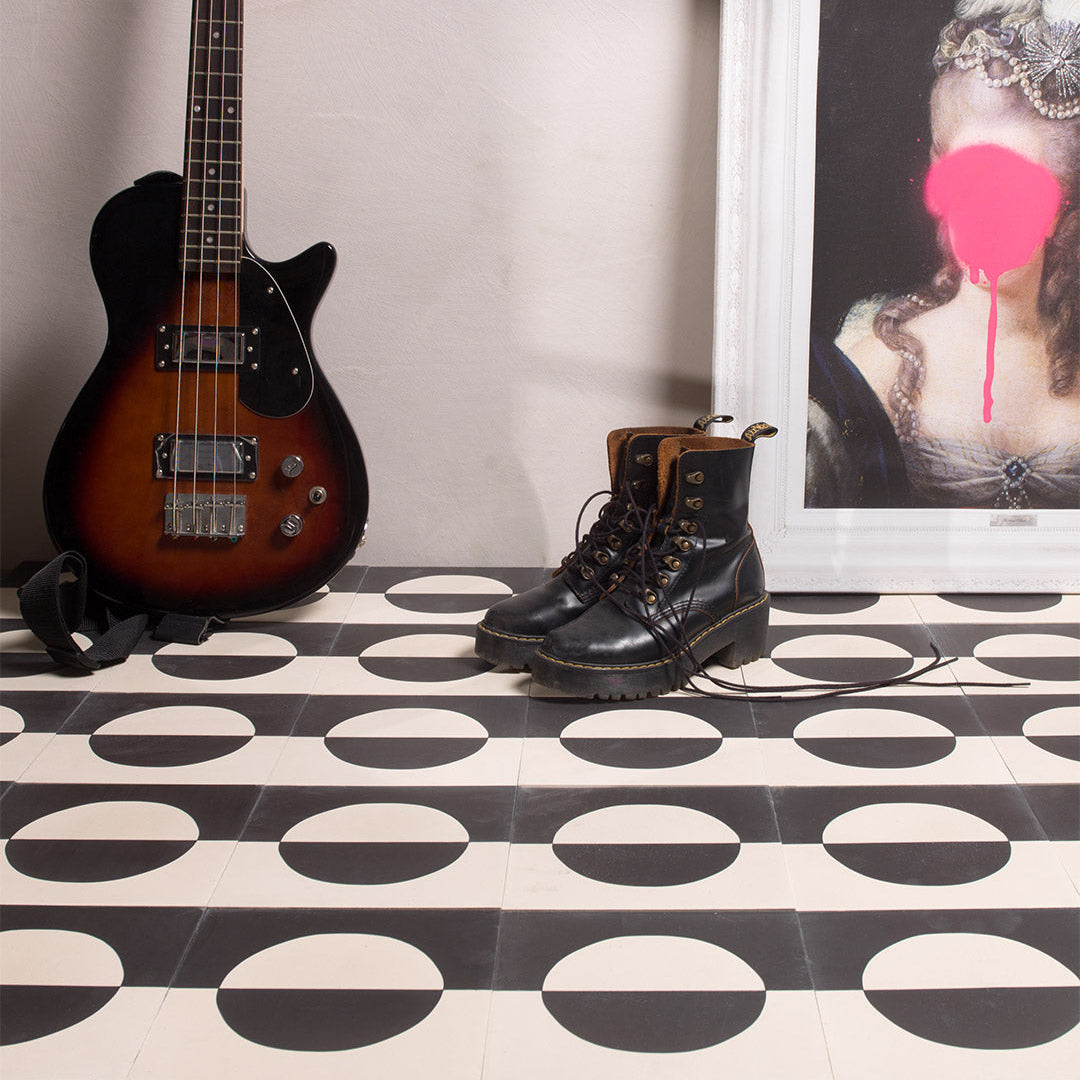 A bold geometric circle pattern in black and off-white tones, matte finish, square shape, ideal for modern, minimalist, or contemporary flooring and wall décor applications.