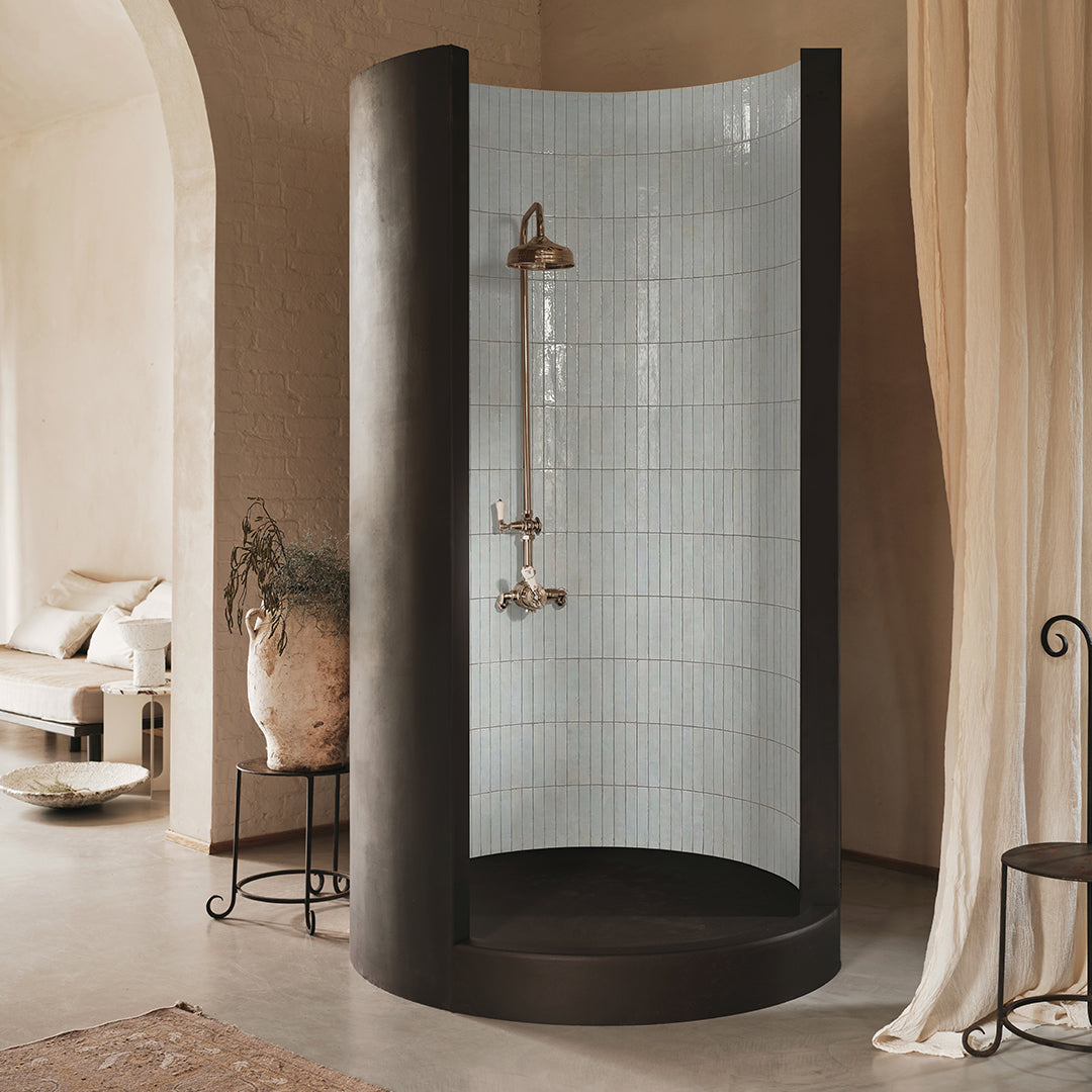 Modern shower enclosure with tiled wall in a bathroom setting