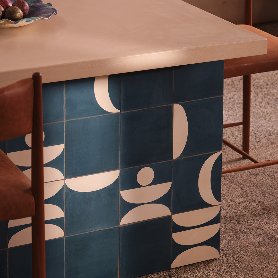 Cement tile featuring abstract geometric shapes in deep teal blue and white, with curved and circular patterns, matte finish, ideal for modern, retro, or mid-century interior flooring and wall décor applications.