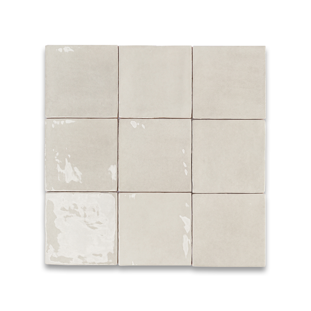 Nine beige ceramic tiles arranged in a 3x3 grid on a white background