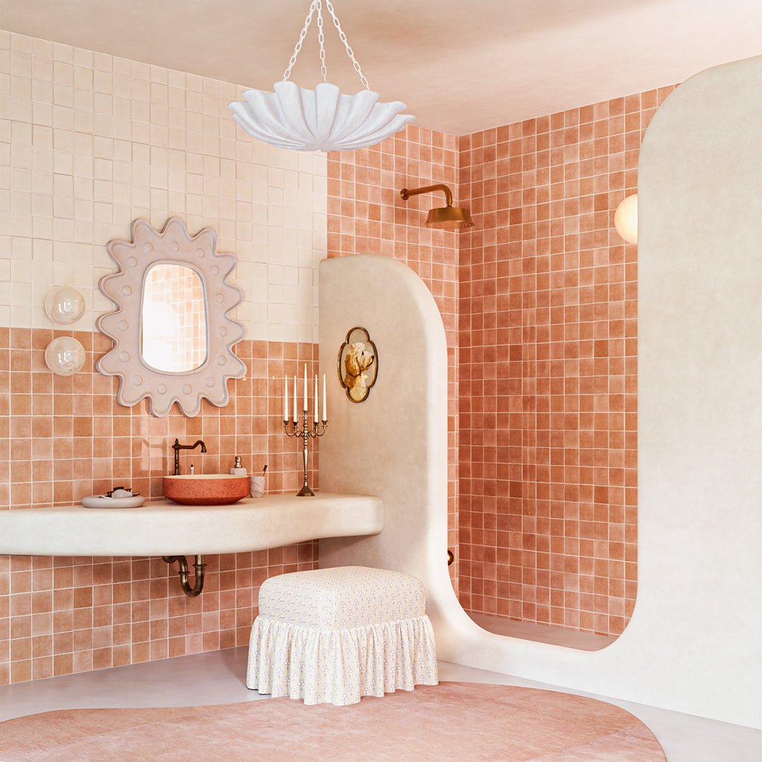 Bathroom interior with tiled walls, sink, and decorative elements.