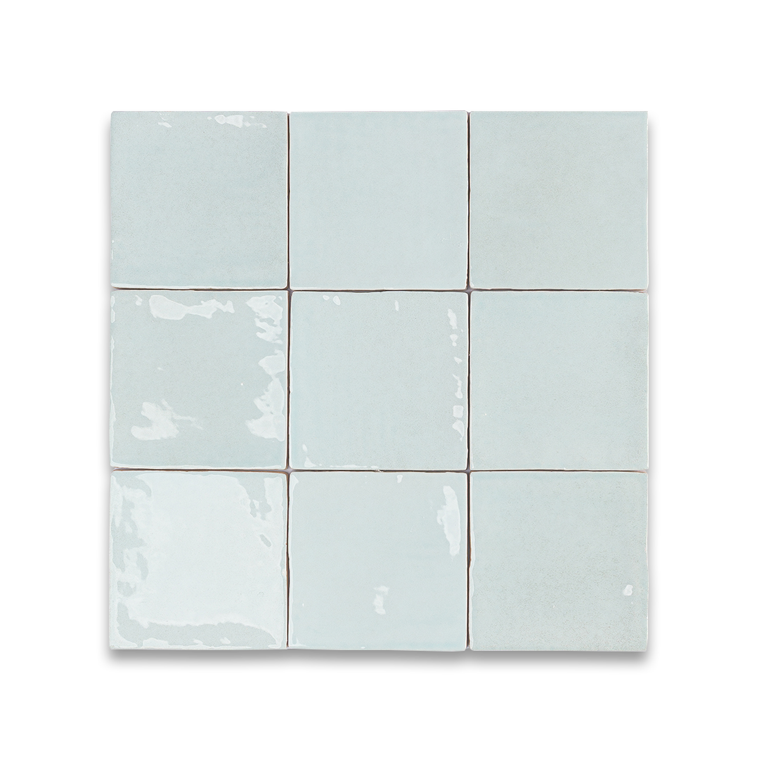 Nine light blue ceramic tiles arranged in a 3x3 grid on a white background