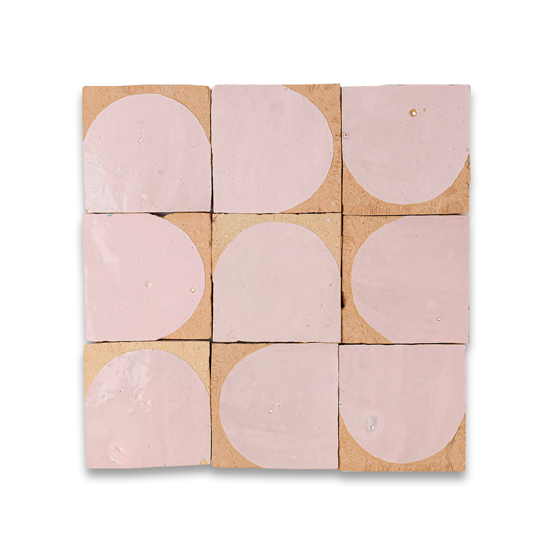 Nine pink circular tiles on a cardboard backing