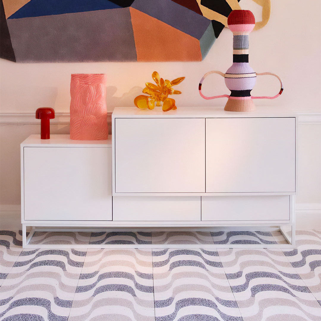 Cement tile featuring a terrazzo wave pattern in black and white tones, curved geometric design, matte finish, ideal for modern, retro, or contemporary interior flooring and wall décor applications.