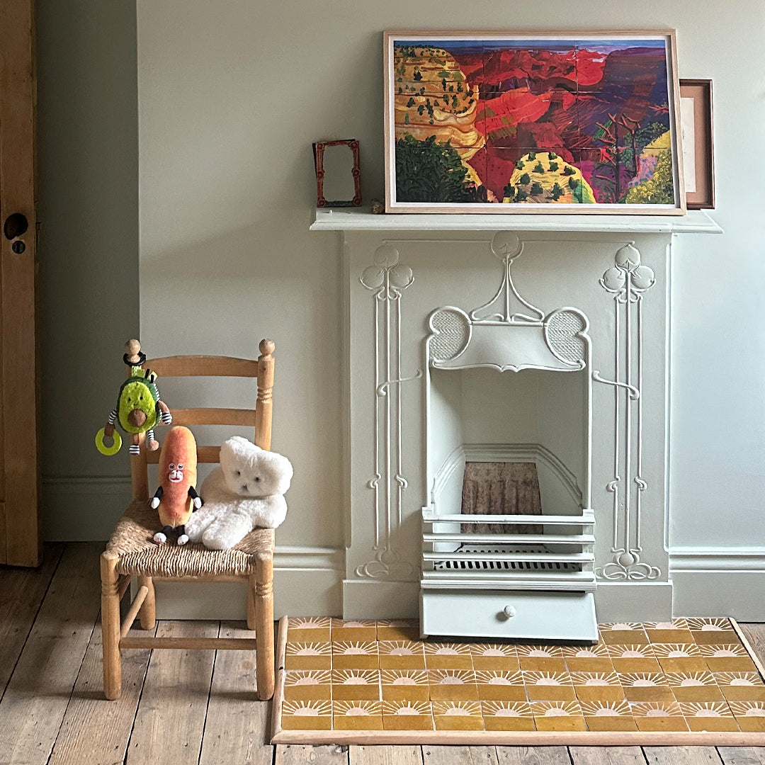 Children's room with a wooden chair, toys, and a decorative rug.