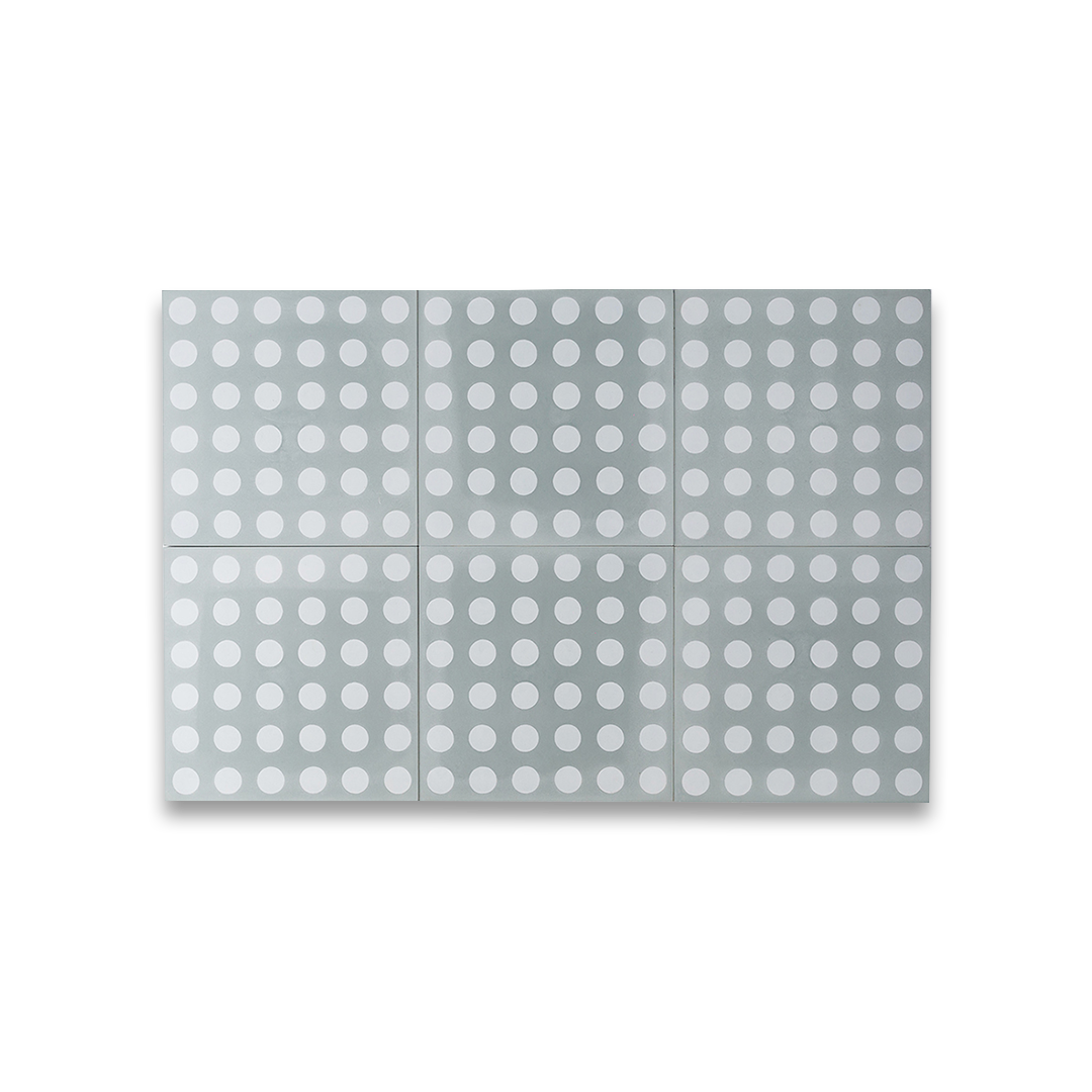 Cement tile featuring a light gray background with evenly spaced white polka dots, matte finish, ideal for retro, playful, or contemporary interior flooring and wall décor applications.