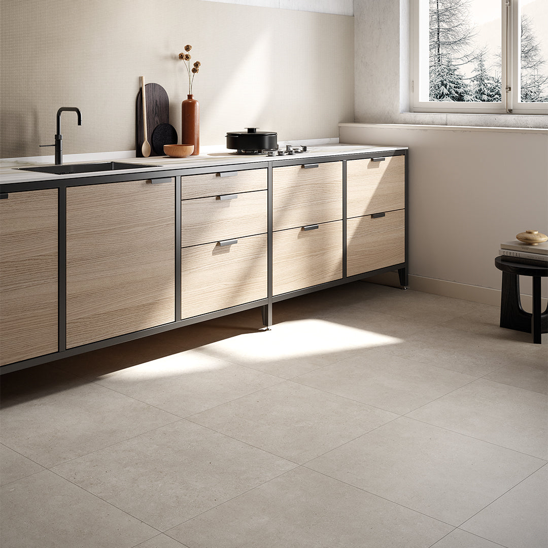 Modern kitchen with wooden cabinets and a window view of trees.