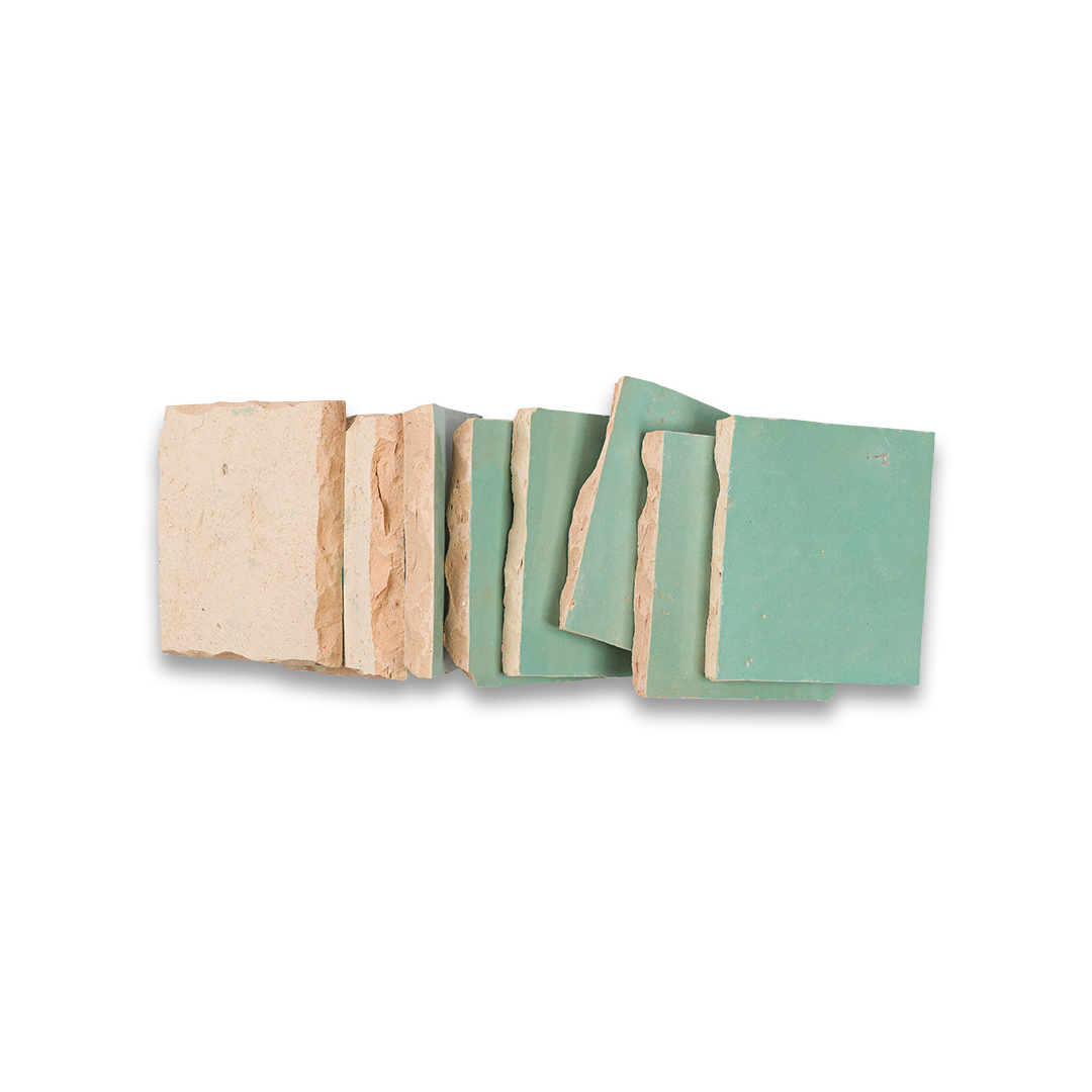Set of wooden coasters with natural and green finishes on a white background