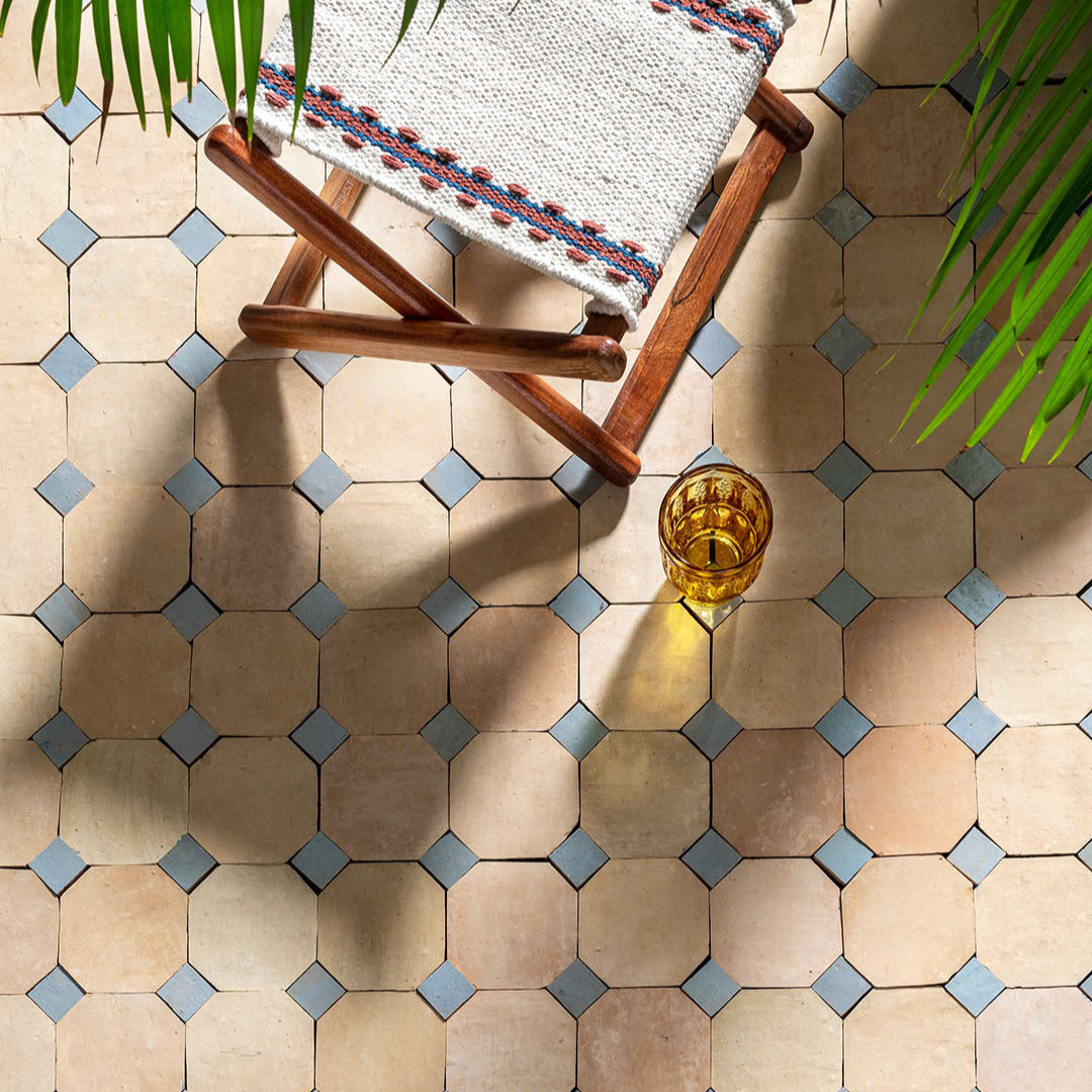 Hexagonal tiles with a wooden chair and glass on a patterned floor
