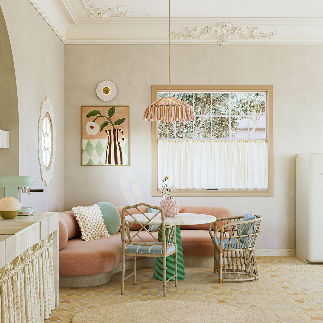 Modern living room with a round table and chairs, artwork on the wall, and a window.