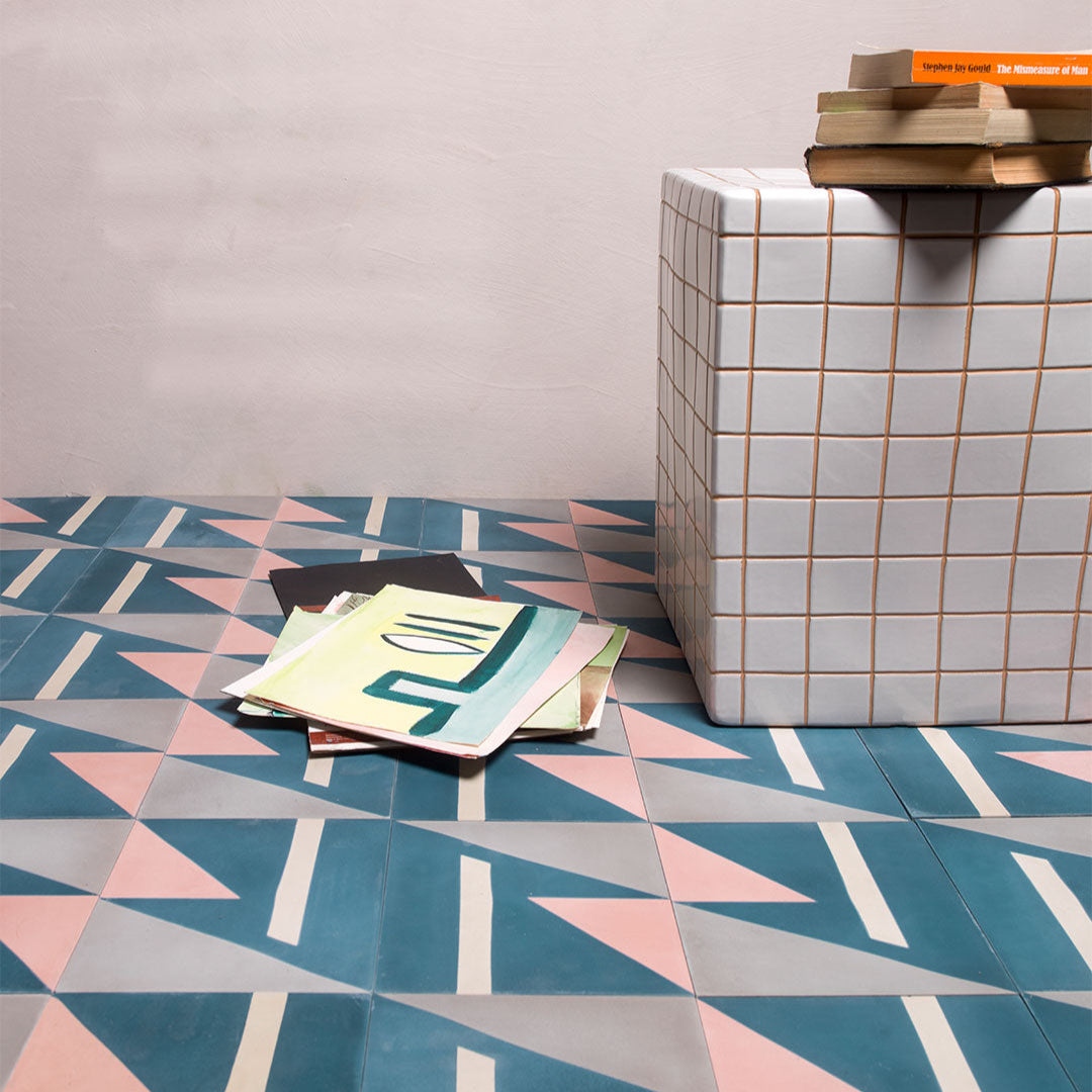 Cement tile featuring geometric shapes in teal blue, blush pink, beige, and gray tones, matte finish, ideal for modern, abstract, or contemporary interior flooring and wall décor applications.