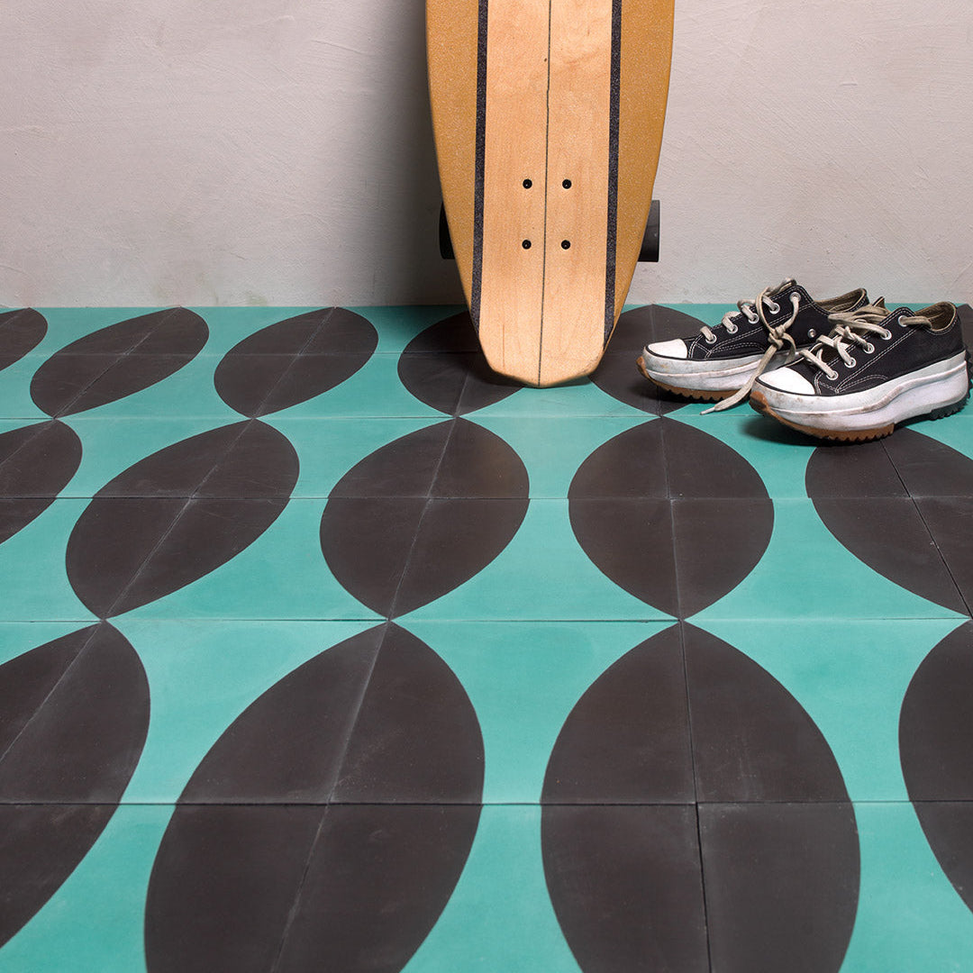Cement tile featuring a curved teal blue geometric pattern on a matte black background, ideal for modern, contemporary, or art deco interior flooring and wall décor applications.