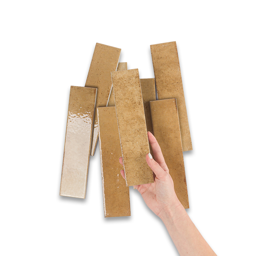 Hand holding a stack of wooden planks on a white background