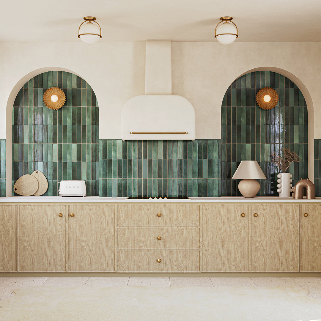 Modern kitchen with green tiled backsplash and wooden cabinets.