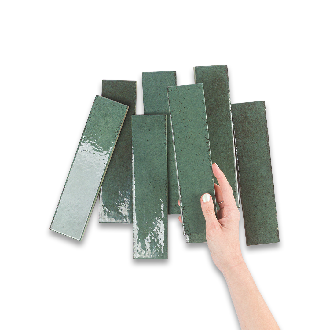 Hand holding a set of green rectangular tiles on a white background