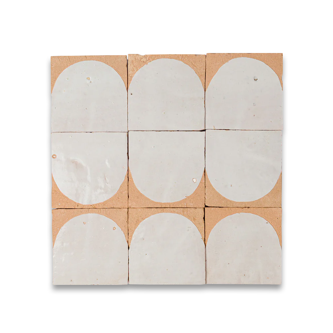 Nine ceramic tiles with circular designs on a cardboard backing