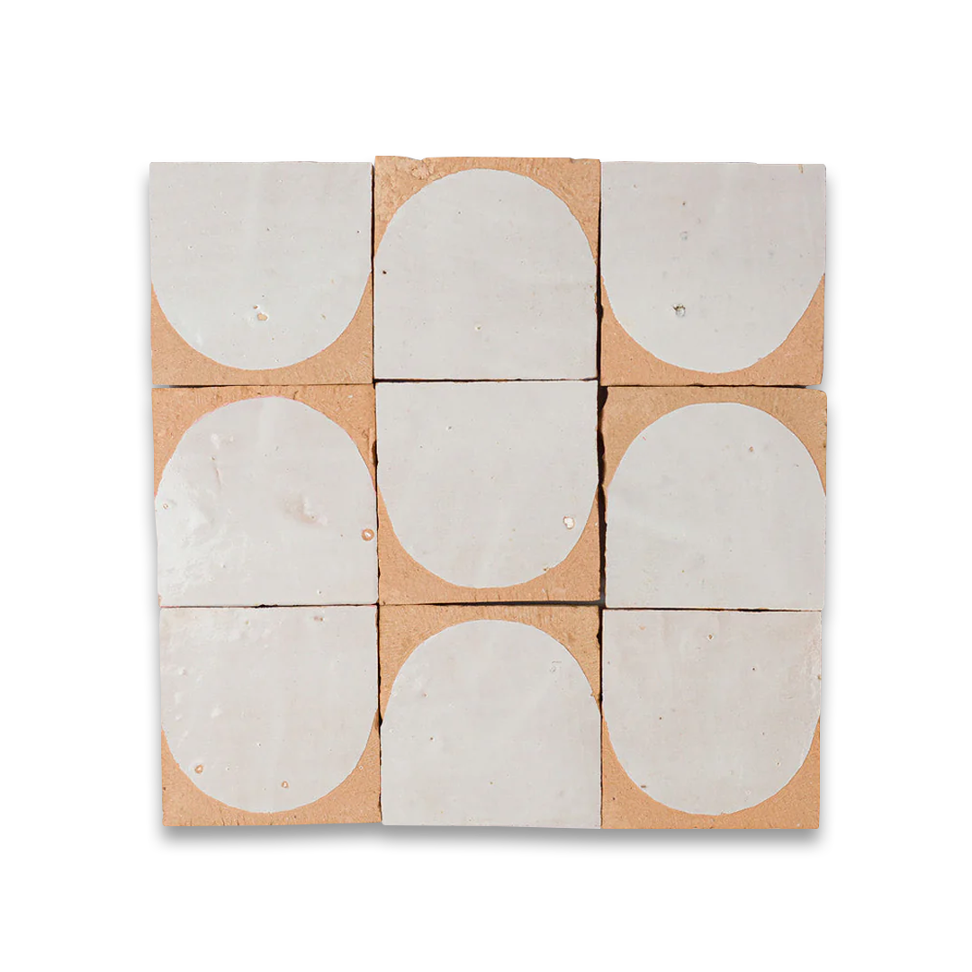 Nine concrete tiles with oval patterns on a cardboard backing