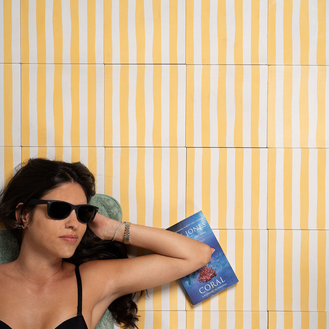 Square cement tile featuring alternating vertical stripes in warm yellow and off-white tones, handcrafted matte finish, ideal for Mediterranean, coastal, or contemporary interior flooring and wall décor applications.