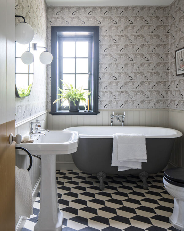 Hex monochrome patterned tiles on bathroom floor bathtub